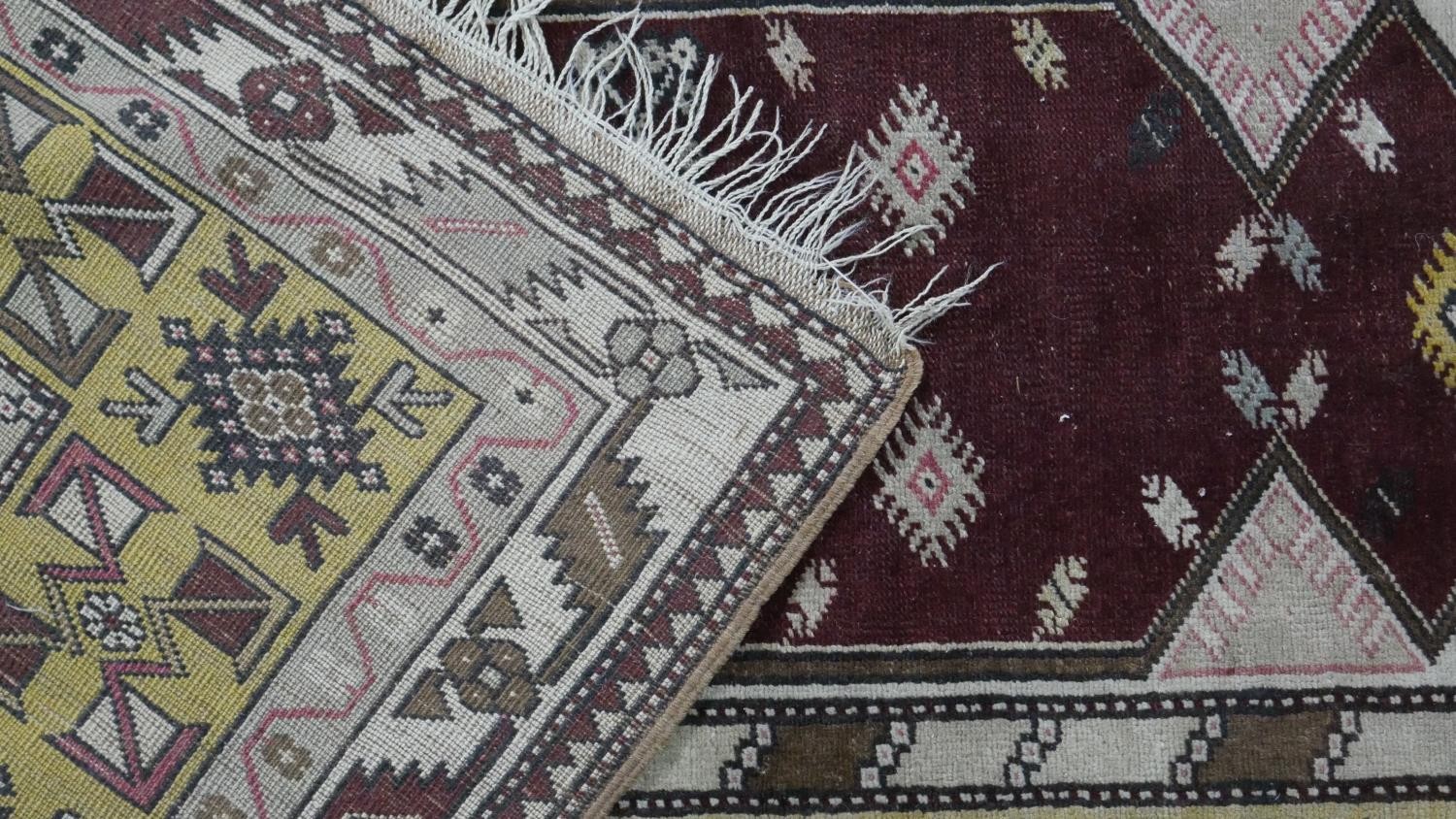 A Turkish Milas rug on a wine ground within stylised multiple borders. L.230 W.127cm - Image 8 of 8