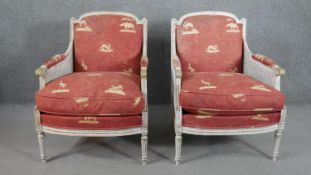 A pair of French Louis XVI style bergere armchairs, the back, arms and seat upholstered in red