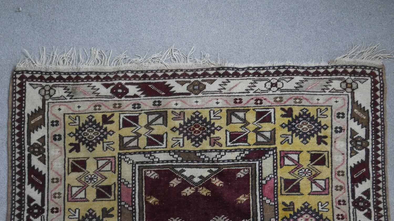 A Turkish Milas rug on a wine ground within stylised multiple borders. L.230 W.127cm - Image 7 of 8