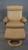 A Norwegian Ekornes Stressless chair & stool, upholstered in tan leather, with a beech frame, on