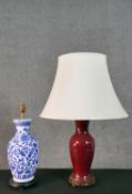 Two Chinese ceramic vase design table lamps, one with oxblood glaze on a pierced and carved base and