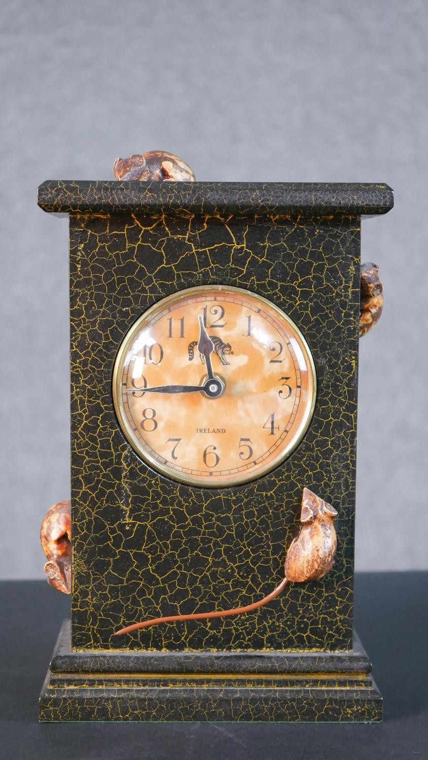 An Irish lacquered and carved mantle clock with crackle finish and with four mice running over the