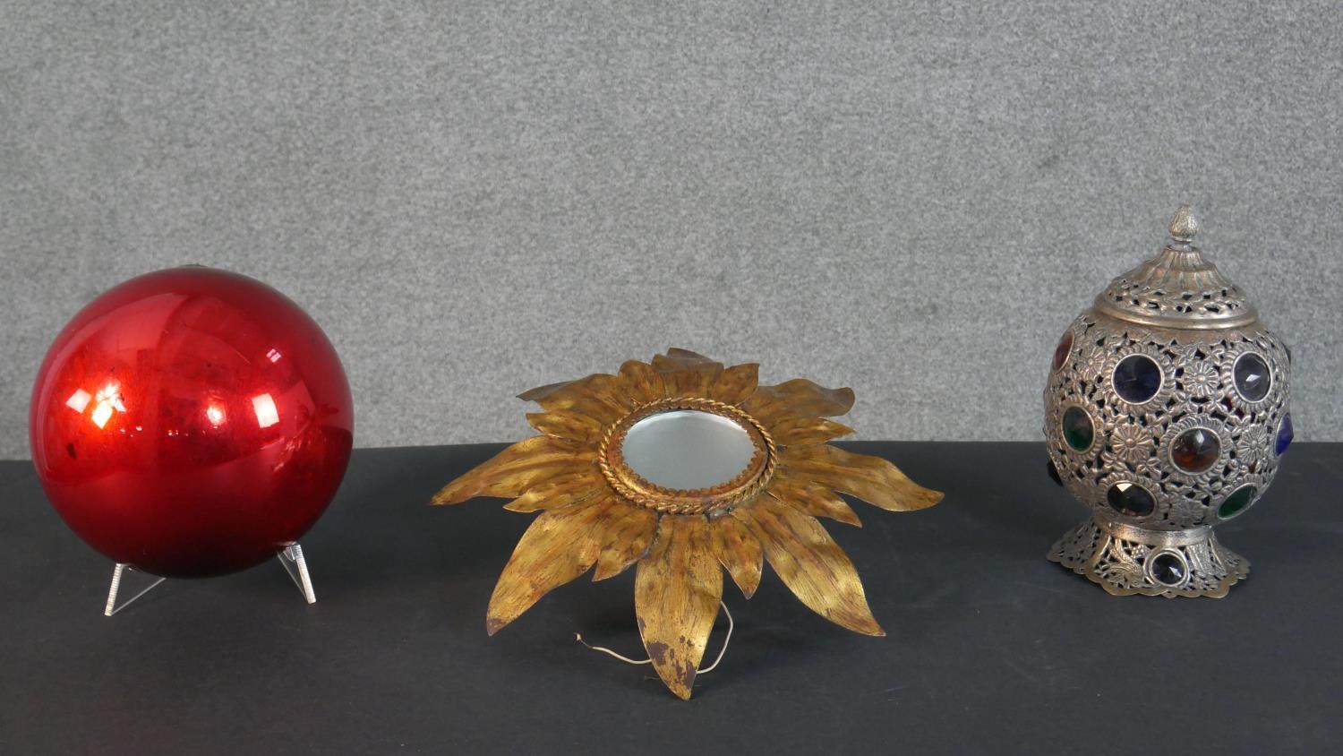 A Moroccan style coloured glass and brass lantern, a large red foil blown glass bauble and a gilt