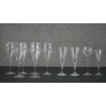 A collection of glasses, including a set of six champagne flutes, and four other assorted glasses.