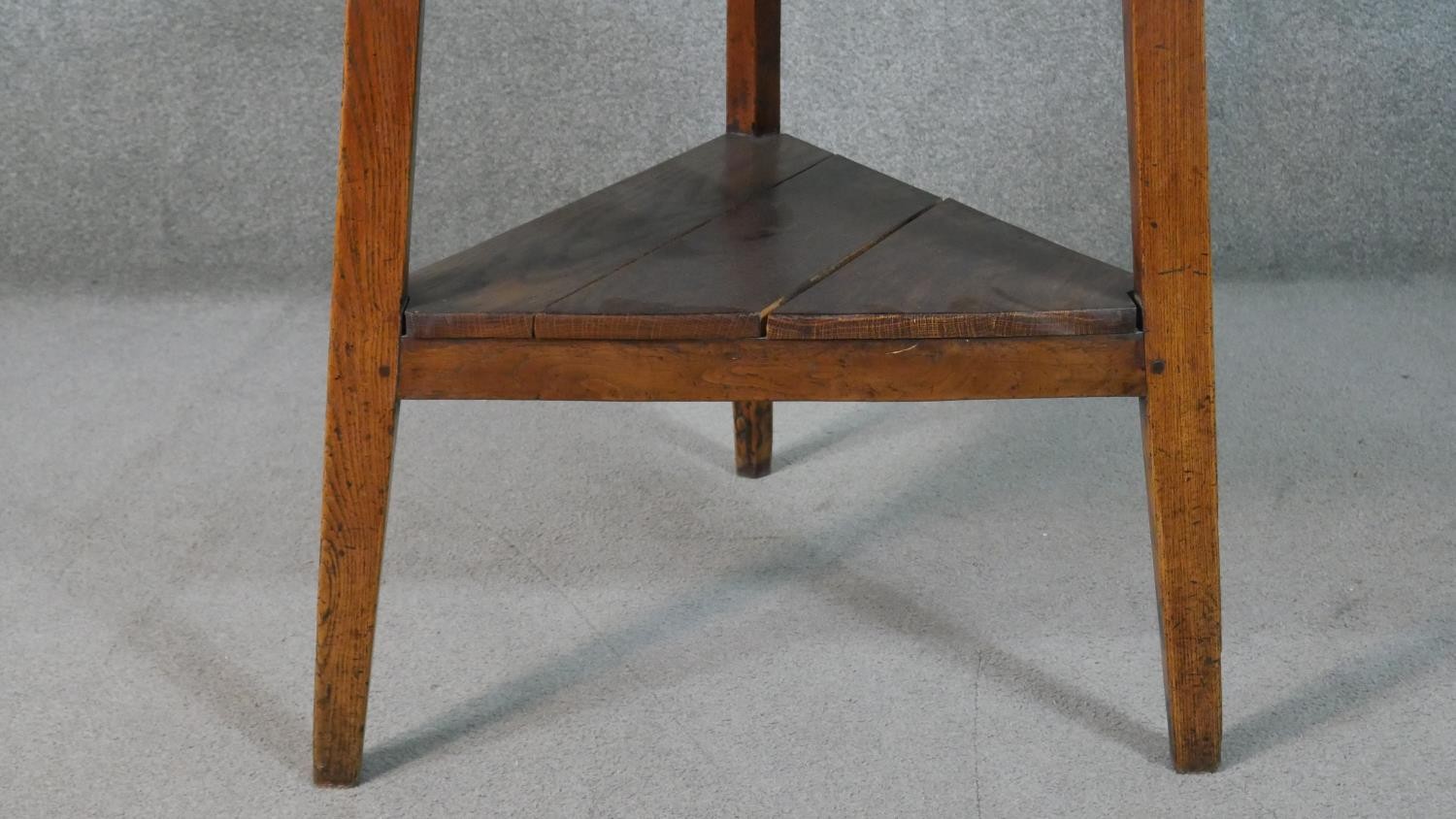 A 19th century country oak cricket table with shaped frieze on splay supports united by an - Image 3 of 5