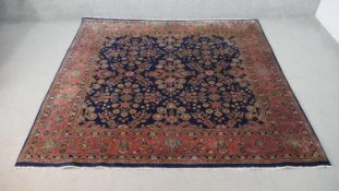 A Persian Sarouk carpet with repeating serrated palm and flowerhead motifs across a midnight field