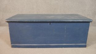 A 19th century pine travelling trunk with twin metal carrying handles, later painted. H.37 W.101 D.