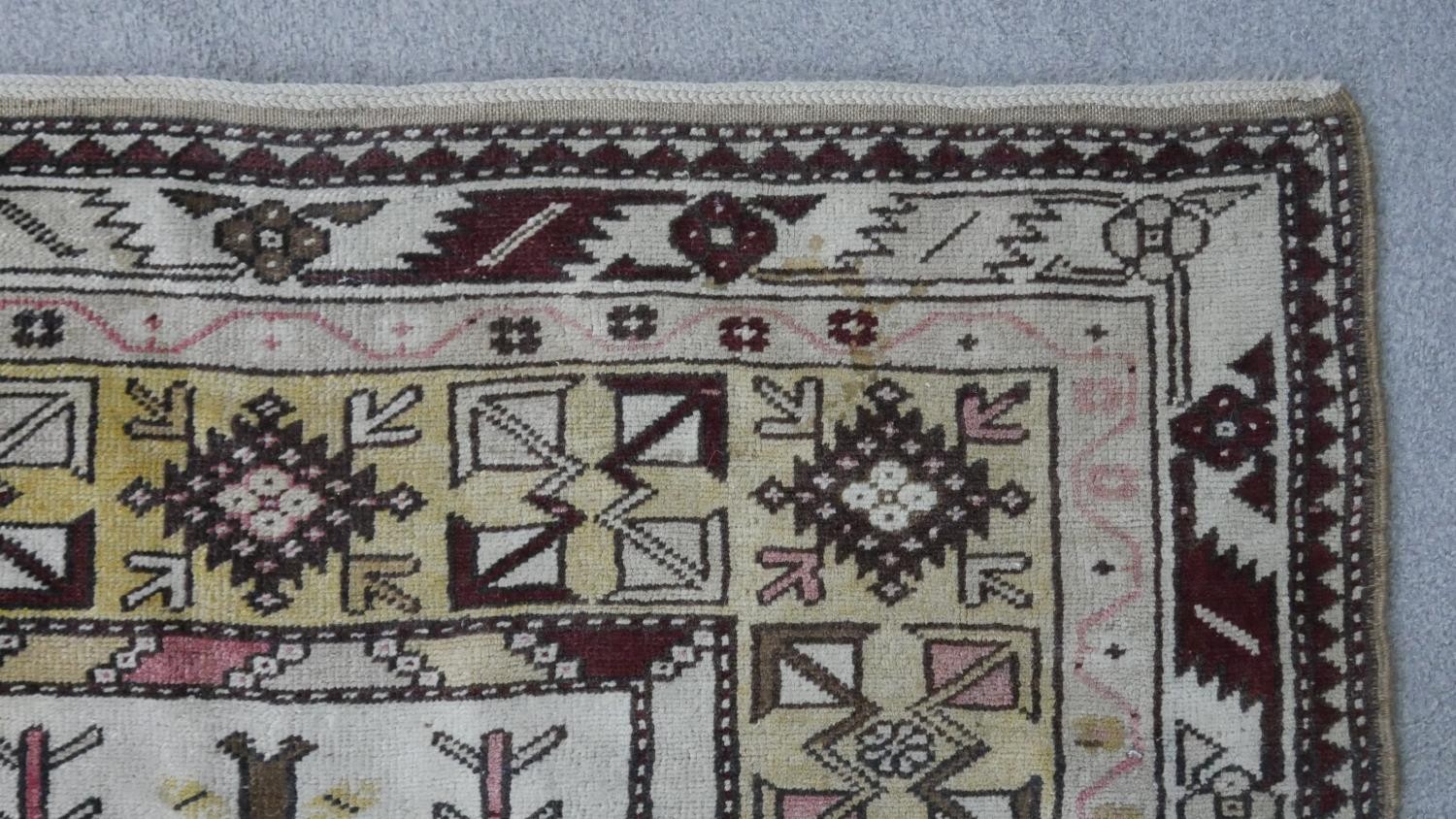 A Turkish Milas rug on a wine ground within stylised multiple borders. L.230 W.127cm - Image 5 of 8