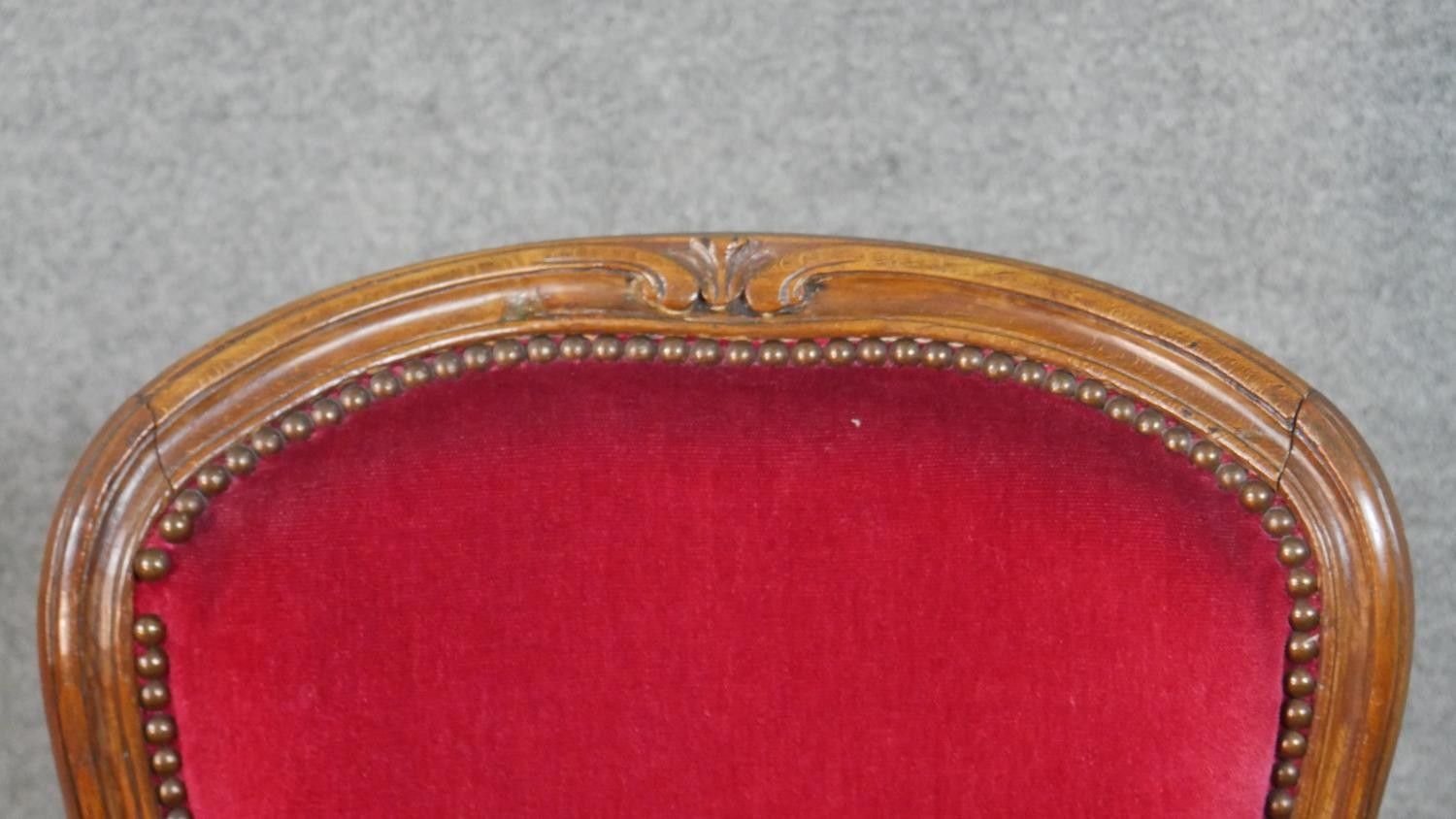 A pair of French walnut Louis XV style fauteuil armchairs, upholstered in red fabric to the back, - Image 6 of 7