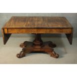 An early Victorian mahogany library table, the rectangular top with two drop leaves, on an