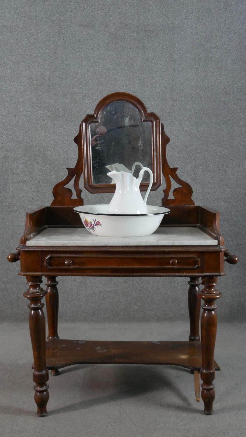 A 19th century mahogany washstand, fitted with swing mirror over a white marble top, above a