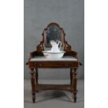 A 19th century mahogany washstand, fitted with swing mirror over a white marble top, above a