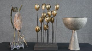 A decorative gilt metal floral figure group on metallic base along with a hammered silver plated
