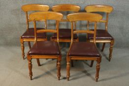A set of five early Victorian walnut bar back dining chairs with burgundy leather drop in seats,
