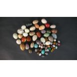 A collection of approximately sixty carved and polished gemstone and mineral eggs, various sizes.