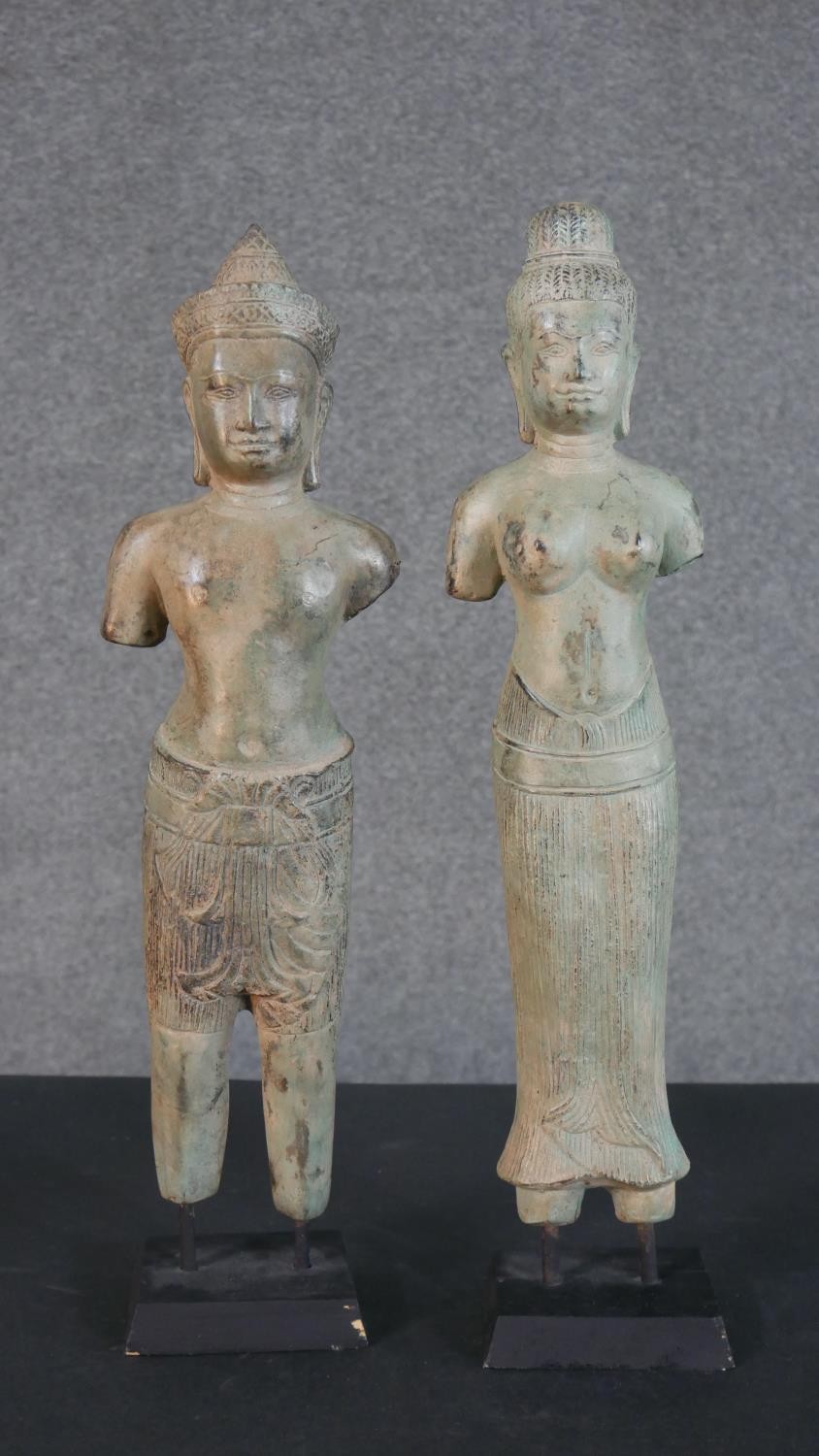 Two Khmer style bronze effect metal figures of two deities on display stands. H.46cm (largest)