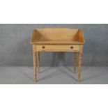 A Victorian pine washstand with raised back and frieze drawer on tapering turned supports. H.47 W.90