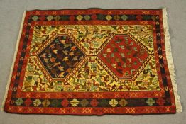 A hand made beige ground Persian Qashqai Sumac rug. L.100 W.77cm.