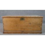 A 19th century pine travelling chest with twin metal carrying handles on plinth base. H.44 W.101 D.