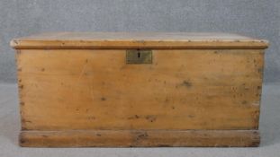 A 19th century pine travelling chest with twin metal carrying handles on plinth base. H.44 W.101 D.
