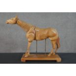 An early 20th century artist's articulated hardwood figure of a horse. Suspended on height