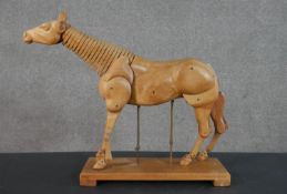 An early 20th century artist's articulated hardwood figure of a horse. Suspended on height