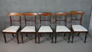 A set of four mid Victorian mahogany bar back dining chairs with drop in seats above turned tapering