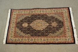 A small hand made blue ground Persian Tabriz rug. L.96 W.60cm.