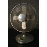 A vintage chrome effect Art Deco electric fan with bakelite control buttons. H.52 W.58 D.28cm.