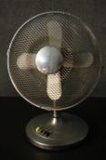 A vintage chrome effect Art Deco electric fan with bakelite control buttons. H.52 W.58 D.28cm.