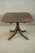 A George III mahogany dining table, the rectangular top with rounded corners and reeded edges, on