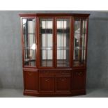 A G-Plan mahogany display cabinet, with four glazed doors, enclosing glass shelves, with a