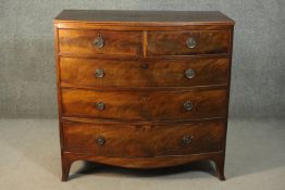 A George III mahogany bow front chest of two short over three long graduated drawers, over a