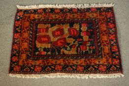 A hand made red ground Persian Sirjan rug. L.68 W.50cm.