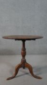 A 19th century country oak tilt top occasional table on tripod cabriole supports. H.72 Diam.71cm
