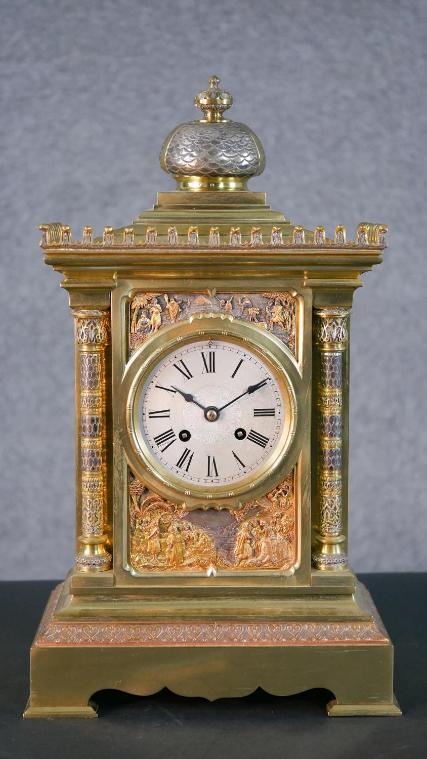 A 19th century tri-metal Egyptian relief design mantle clock of architectural form. Brass movement