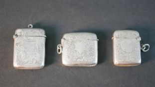 Three engraved floral and foliate design silver match strikers. Birmingham assay marks and various