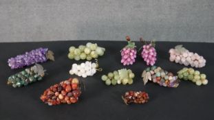 A collection of twelve decorative bunches of grapes, two bunches of glass grapes and other various
