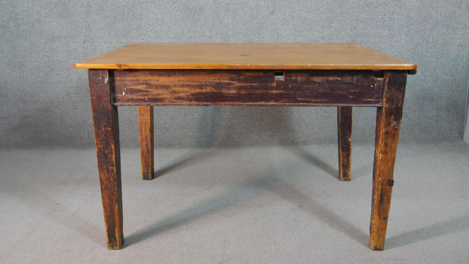A C.1900 planked top kitchen table on distressed square section tapering supports. H.74 W.119 D.82cm - Image 2 of 8