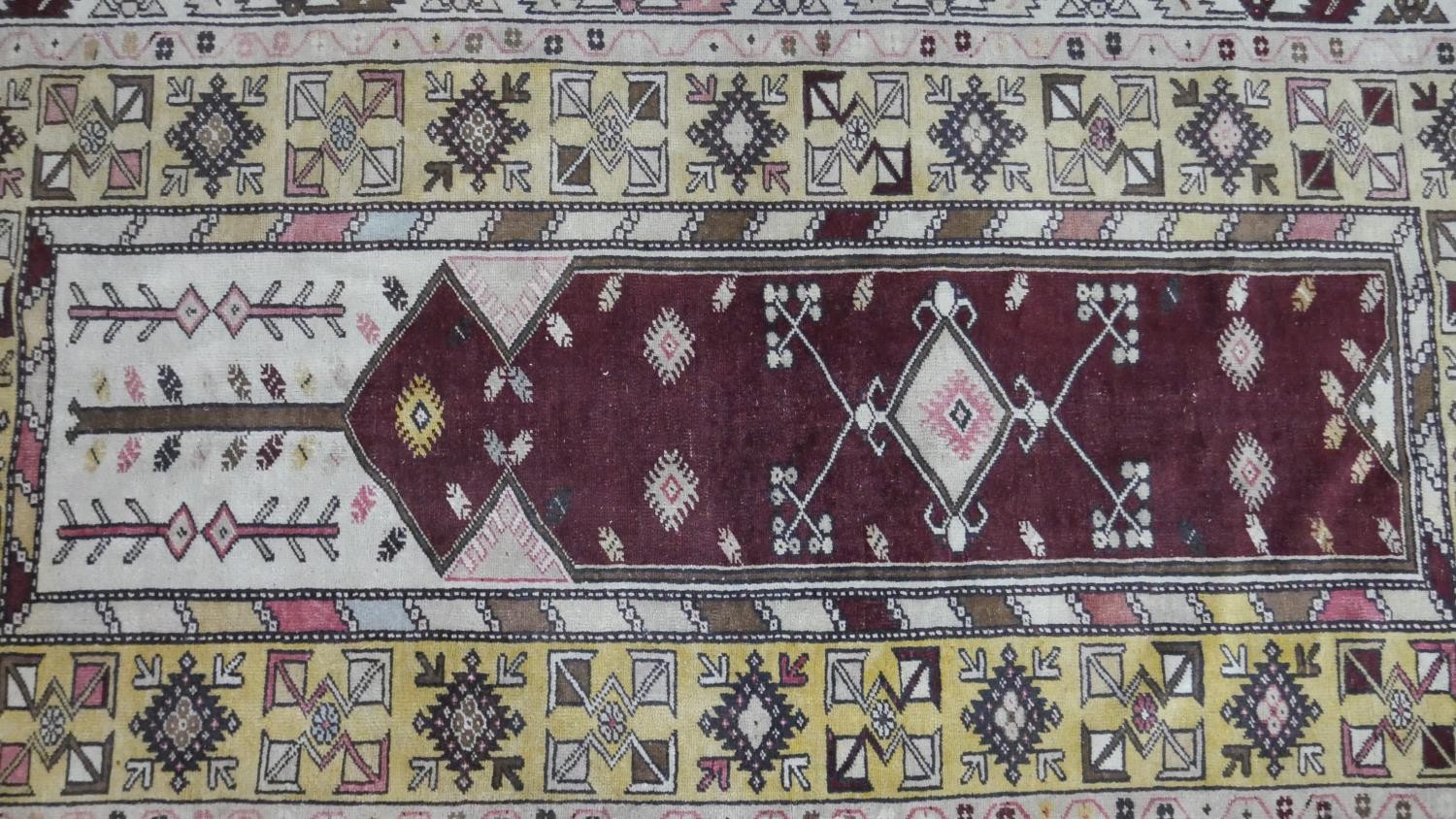 A Turkish Milas rug on a wine ground within stylised multiple borders. L.230 W.127cm - Image 2 of 8