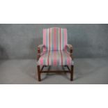 A mahogany Gainsborough style open armchair, upholstered in striped fabric to the back, seat and