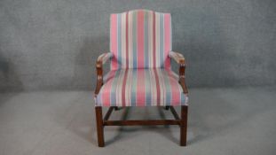 A mahogany Gainsborough style open armchair, upholstered in striped fabric to the back, seat and