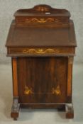 An Edwardian rosewood Davenport, the superstructure with a rising lid and fitted interior, over a