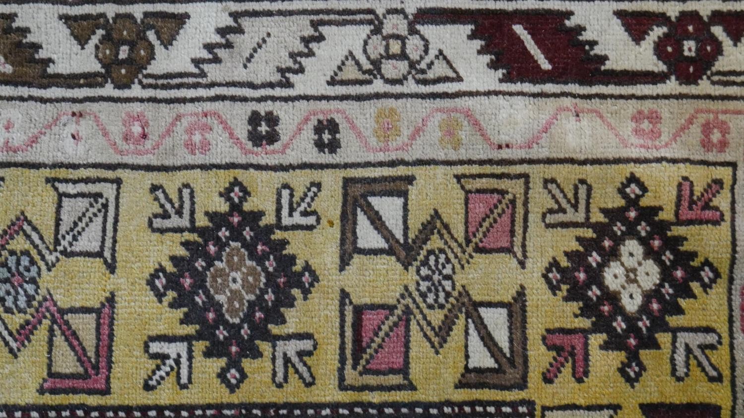 A Turkish Milas rug on a wine ground within stylised multiple borders. L.230 W.127cm - Image 6 of 8