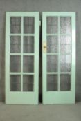 A pair of vintage light blue painted doors, lead set with textured glass panels. H.202 W.73cm. each.
