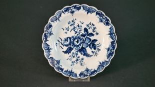 An 18th century Worcester blue and white hand painted floral design plate. Blue crescent mark to the