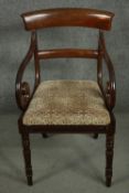 A Regency mahogany bar back open armchair, with scrolling arms, over a drop in seat, on turned legs.