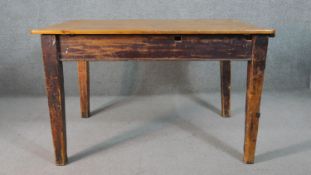 A C.1900 planked top kitchen table on distressed square section tapering supports. H.74 W.119 D.82cm