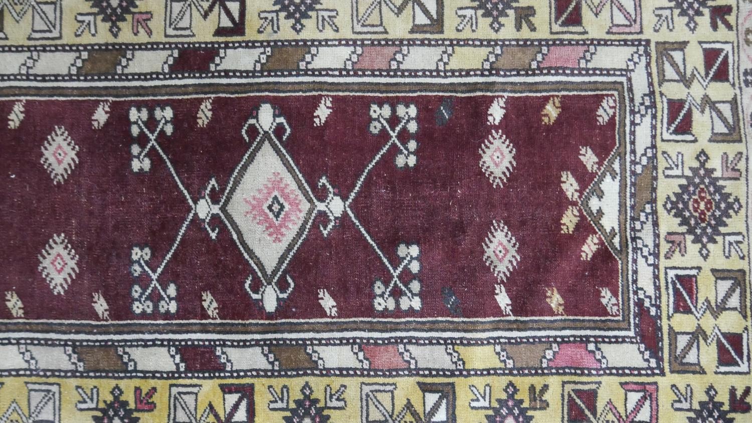 A Turkish Milas rug on a wine ground within stylised multiple borders. L.230 W.127cm - Image 4 of 8