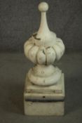 A large painted carved decorative finial with gadrooned design on a pedestal base. (two sections